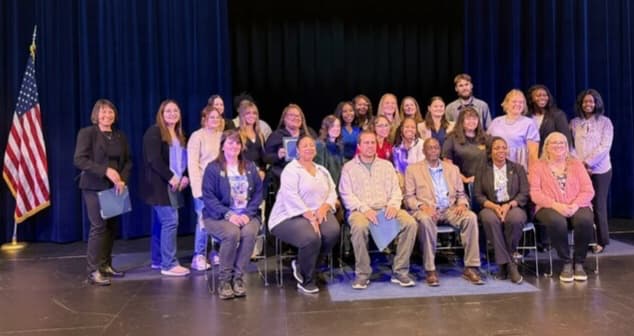 A large group of people in chairs. 