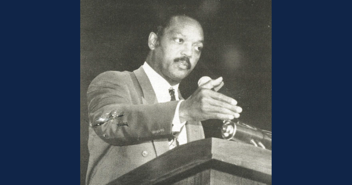 Black and white image of Rev. Jesse Jackson giving a speech at a podium in Richardson Auditorium on the Lincoln University campus. 