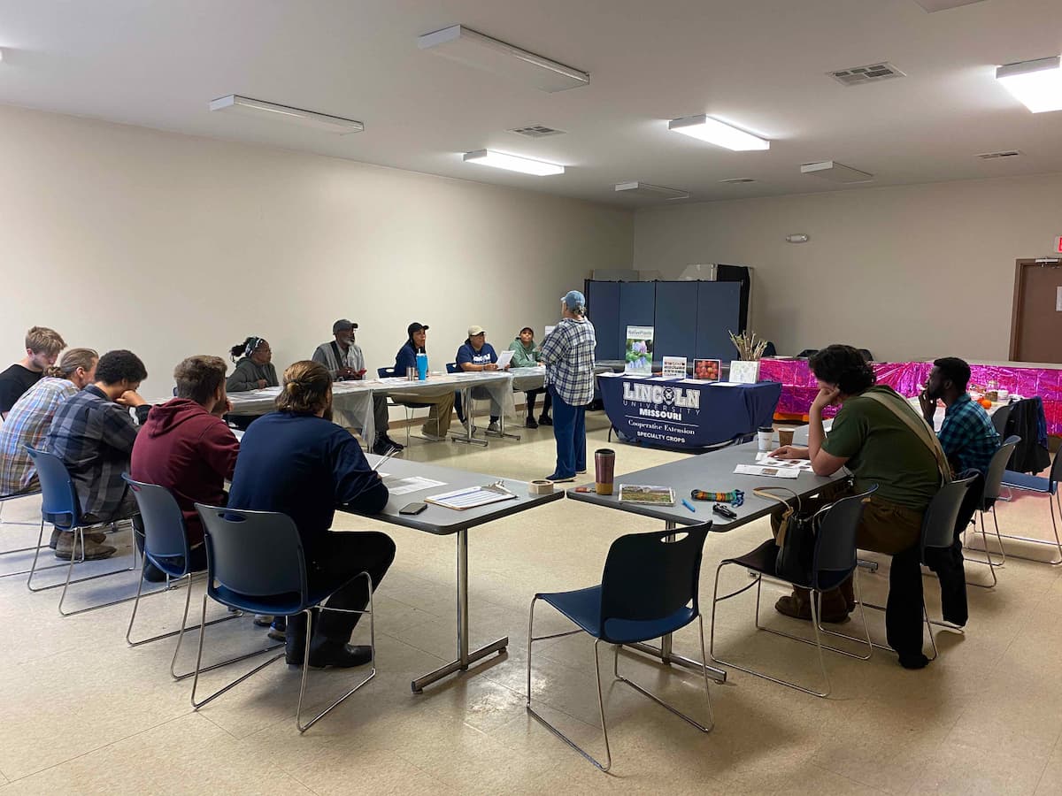 Participants sit around tables in a classroom in Haywood City during an indoor pruning session before moving outside for hands-on work.