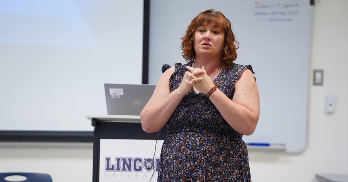 Woman standing in front of a podium.