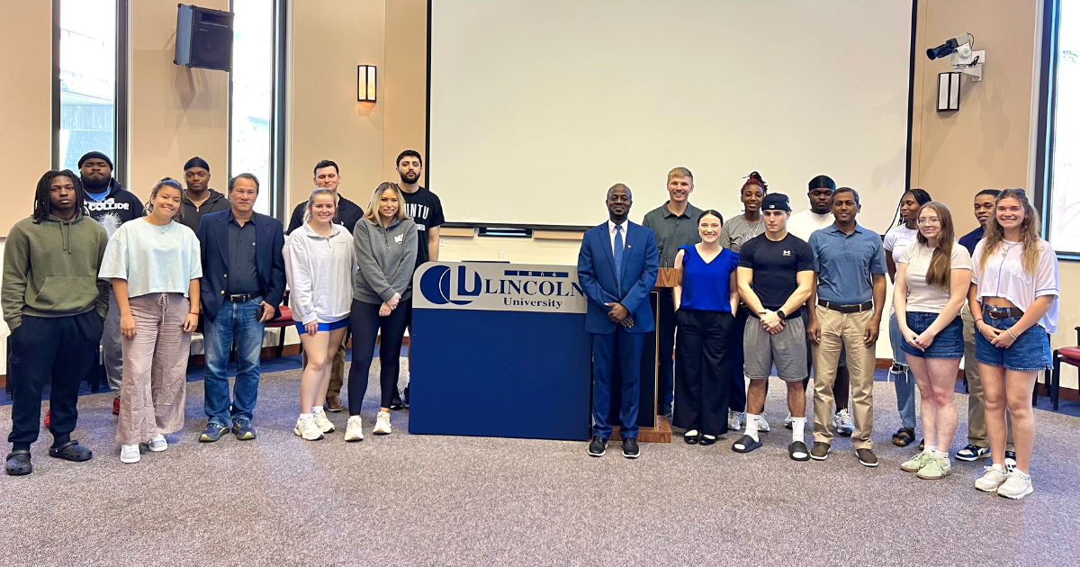 Lincoln University business students stand in a line for a photograph at the business hackathon event. 