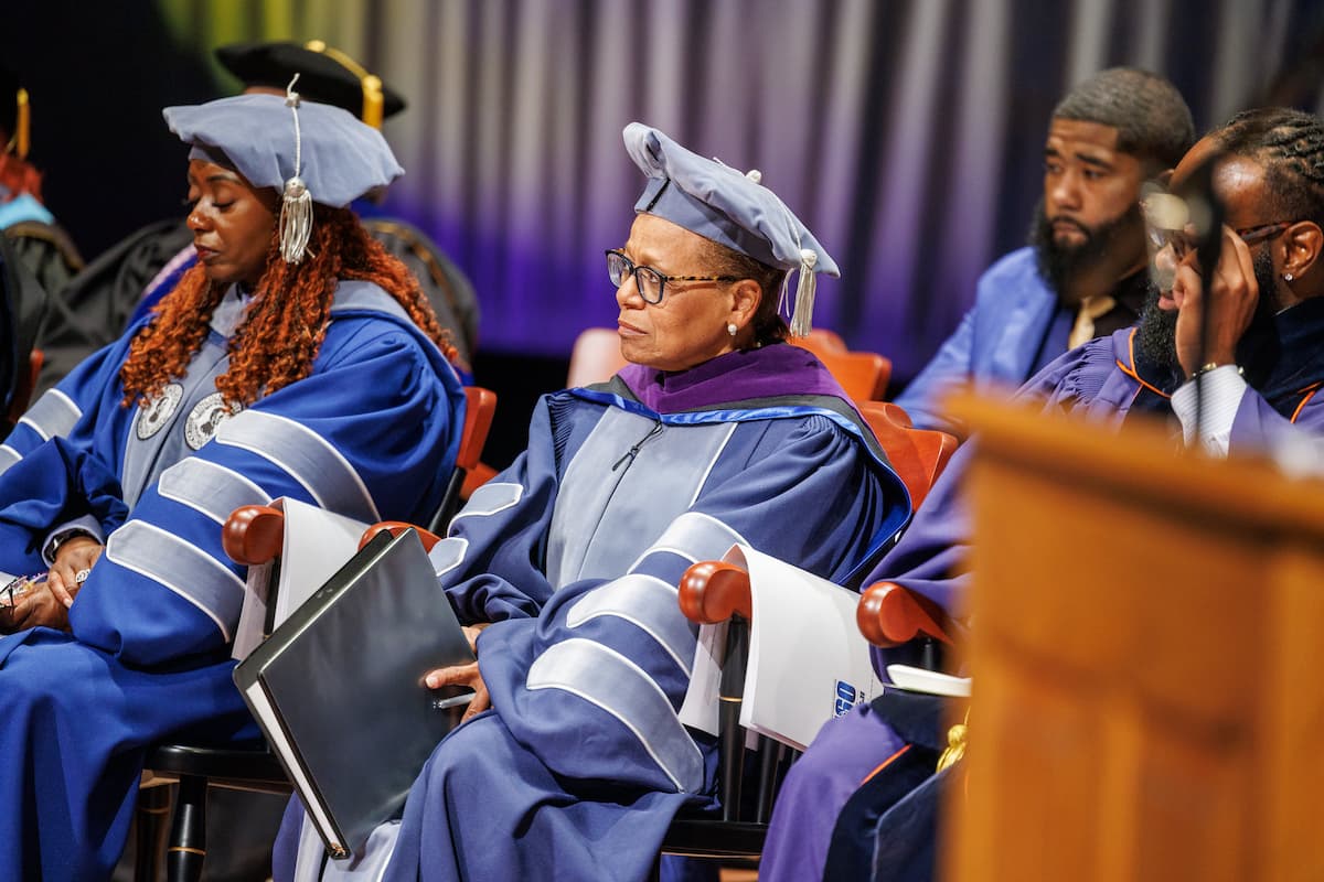 Chief Hudson sits in a chair in Mitchell Auditorium during the 2026 Honors Convocation.