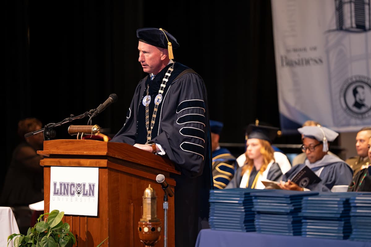 Lincoln University President Moseley stands at a podium while giving a speech.