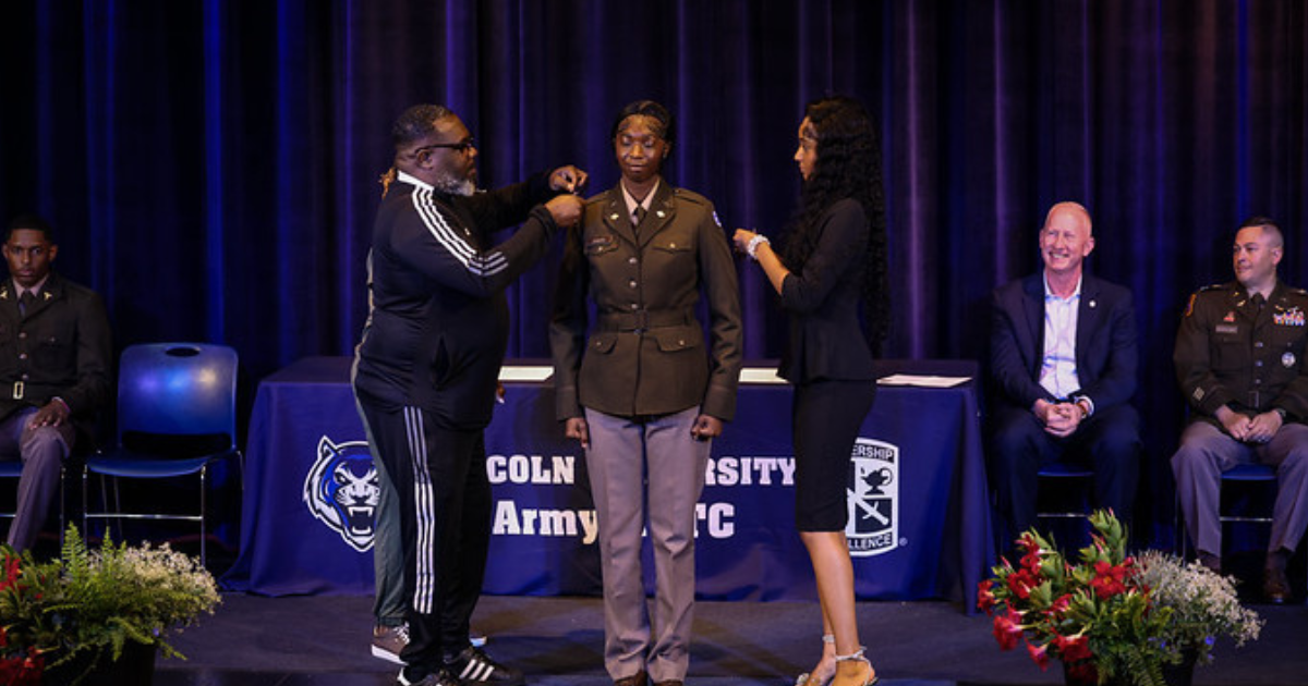 Family members pin second lieutenant insignia on a Lincoln University ROTC cadet during the Spring 2026 commissioning ceremony.
