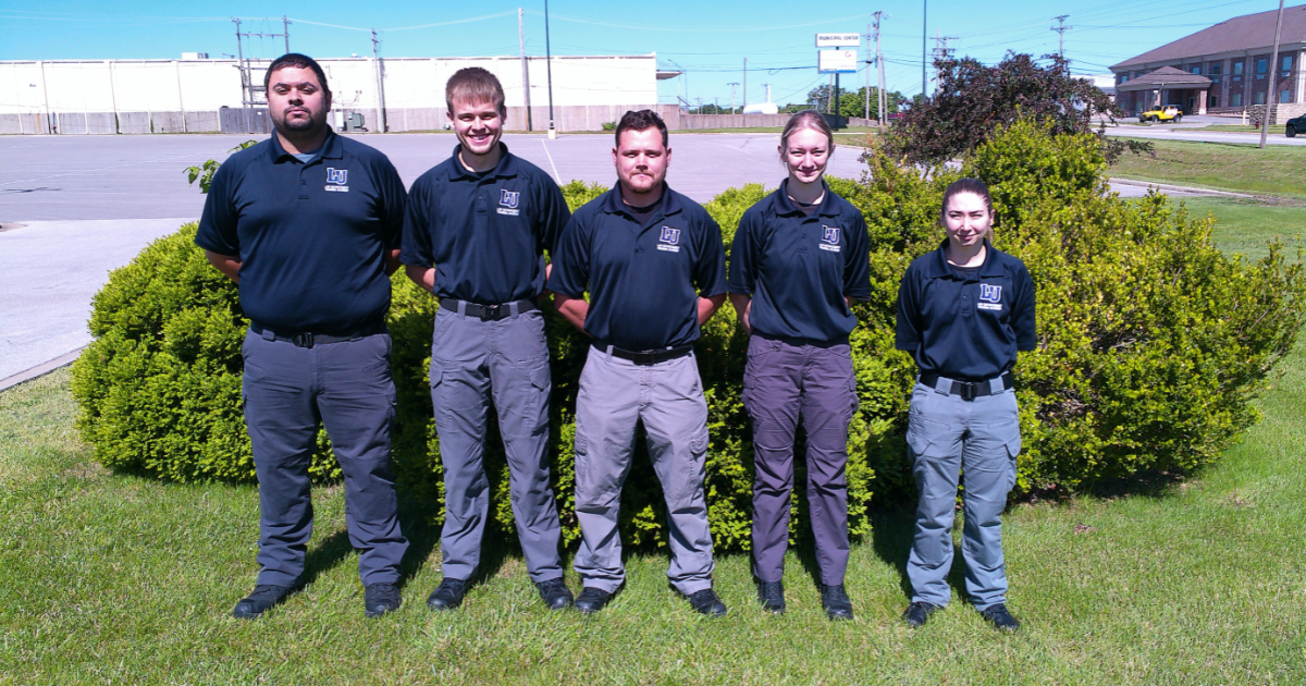 Five St. Robert LULETA graduates stand outside and smile for a photo.