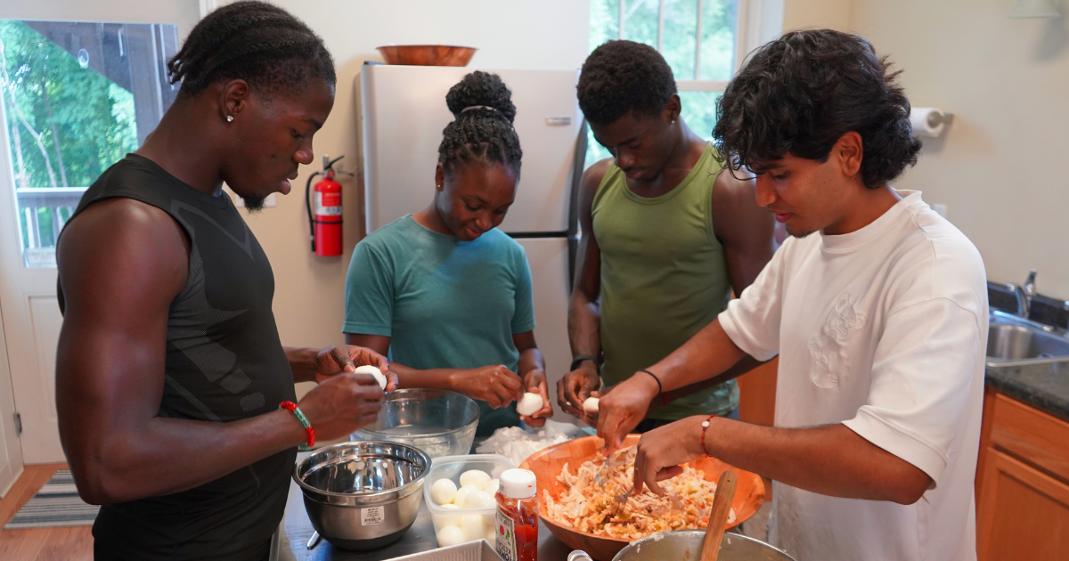 From left, Tedane Williams, Monae Carey and Vincent Osei peel eggs while Omar Santiago Pineda Otalvaro mixes ingredients in the kitchen at Common Ground Community Building.