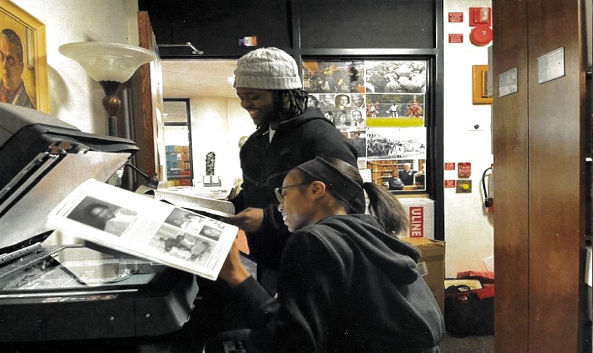 Student workers Troy and Ronita digitize materials in the Lincoln University Archives.