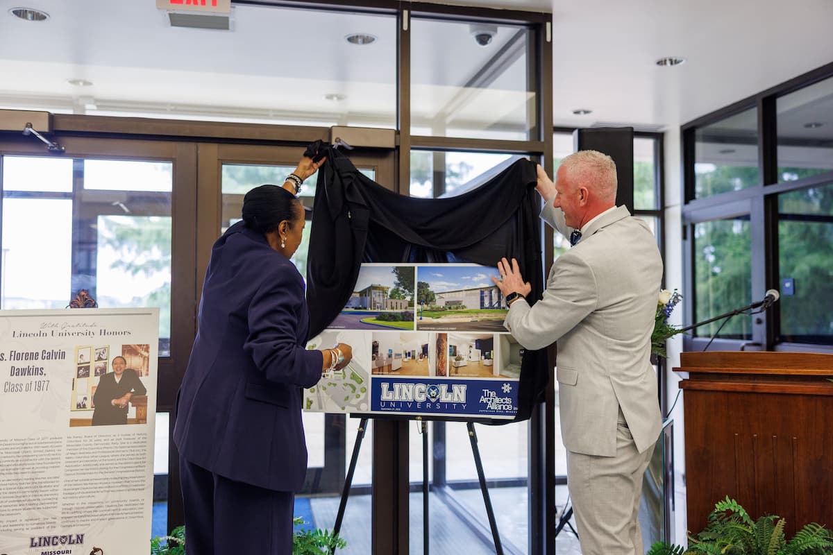 Florene Dawkins and President Moseley unveil a rendering of a proposed Lincoln welcome center.