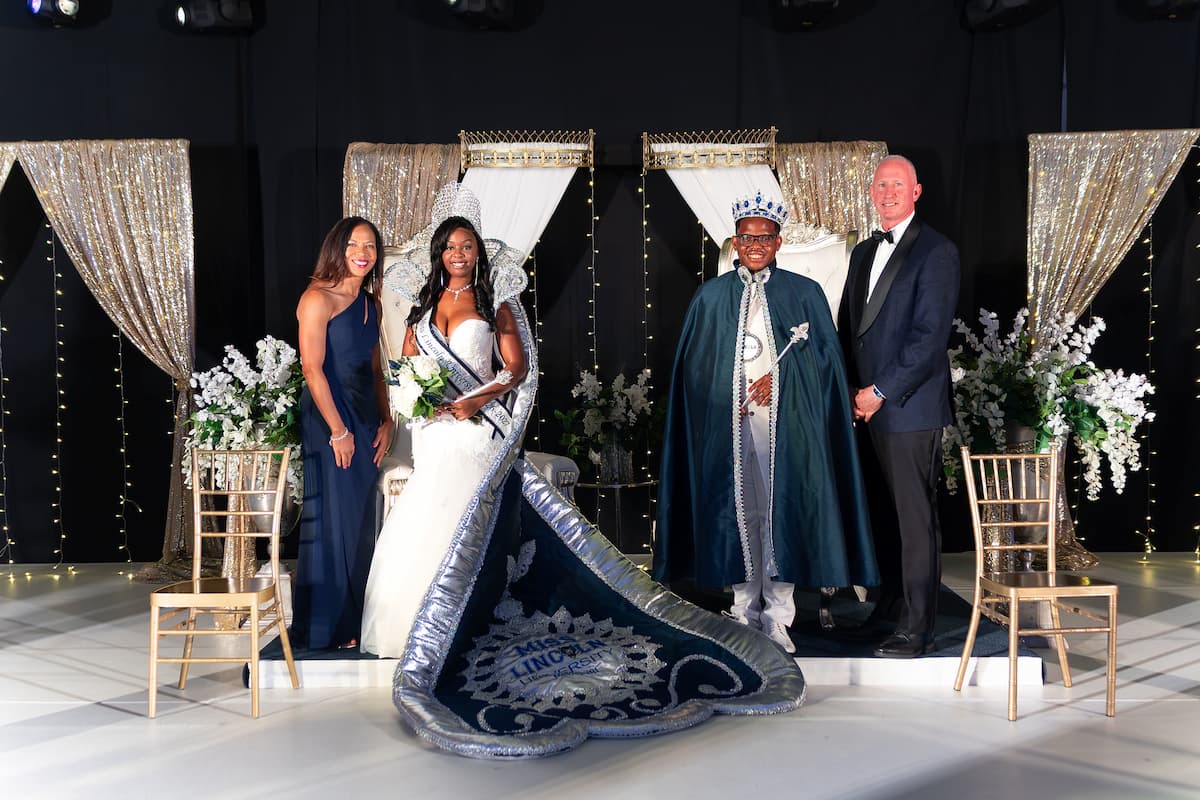 Two women and two men smile for a photo at the 2026 Homecoming Coronation.