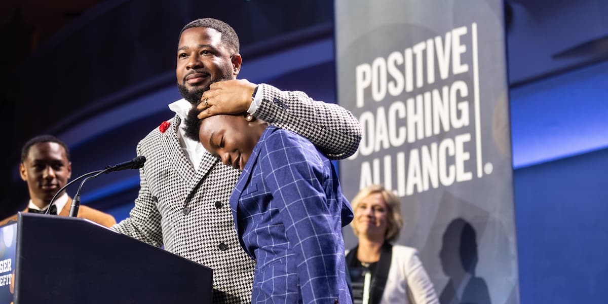 Dream Team founder Jareem Gunter with one of his players during a Positive Coaching Alliance event.