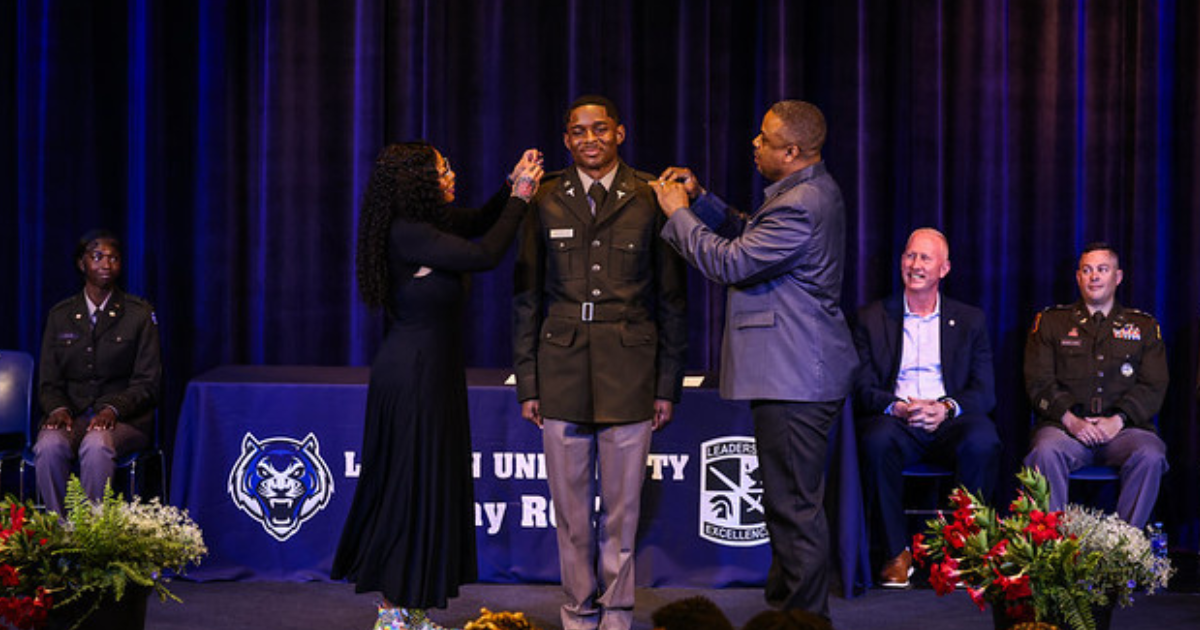 Family members pin second lieutenant insignia on a Lincoln University ROTC cadet during the 2026 commissioning ceremony.