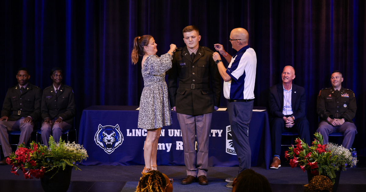 Family members pin second lieutenant insignia on a Lincoln University ROTC cadet during the 2026 commissioning ceremony.