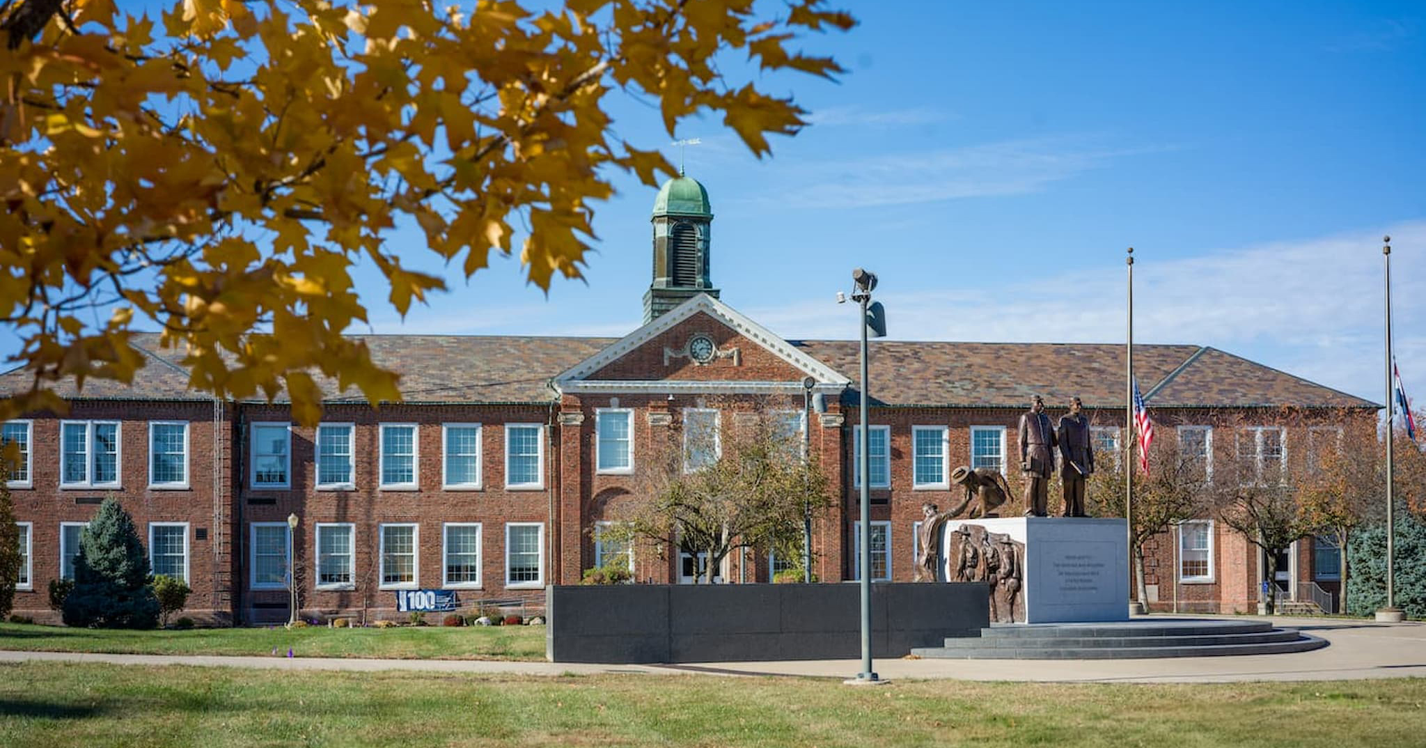 Young Hall at Lincoln University of Missouri, a historic red-brick academic building with a clock tower, fall foliage, and Soldiers Memorial in front